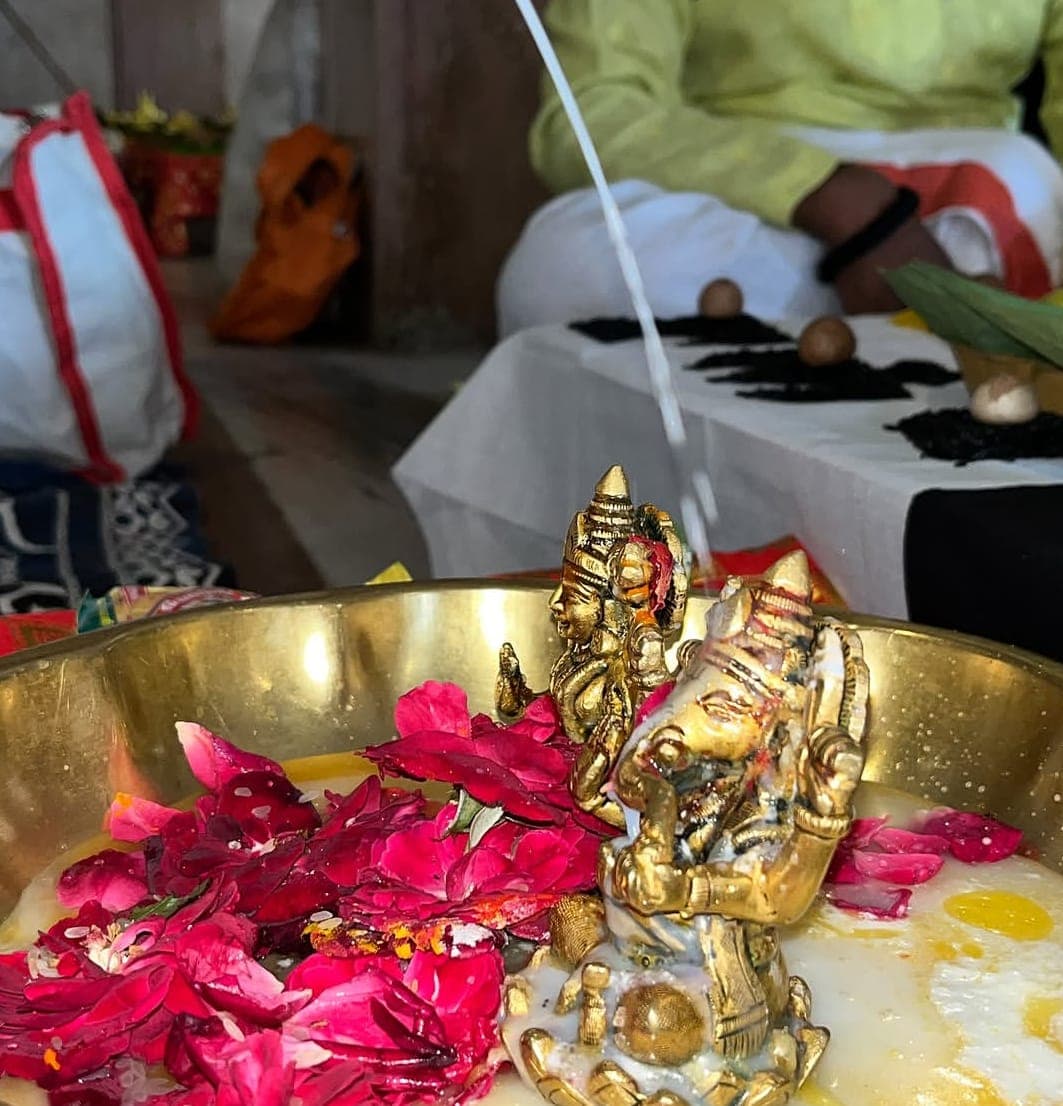 Rudraksha mala and bilva leaves arranged for puja
